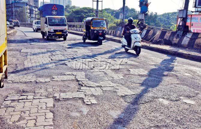 The Western Express Highway has been ailing with potholes and bumper-to-bumper traffic. Pic/Bipin Kokate