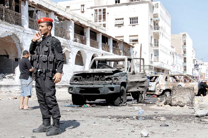 A member of Yemeni security forces stands guard next to the central bank in Yemen’s second city Aden. Pic/AFP