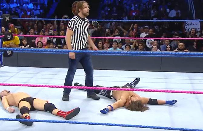 Ambrose (c) stands over a fallen Ellswoth (l) and Styles