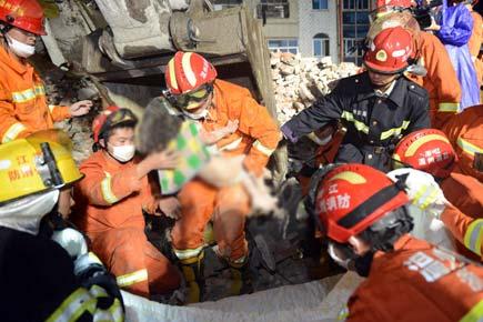 China building collapse: Girl wrapped in dead parents' arms found alive 