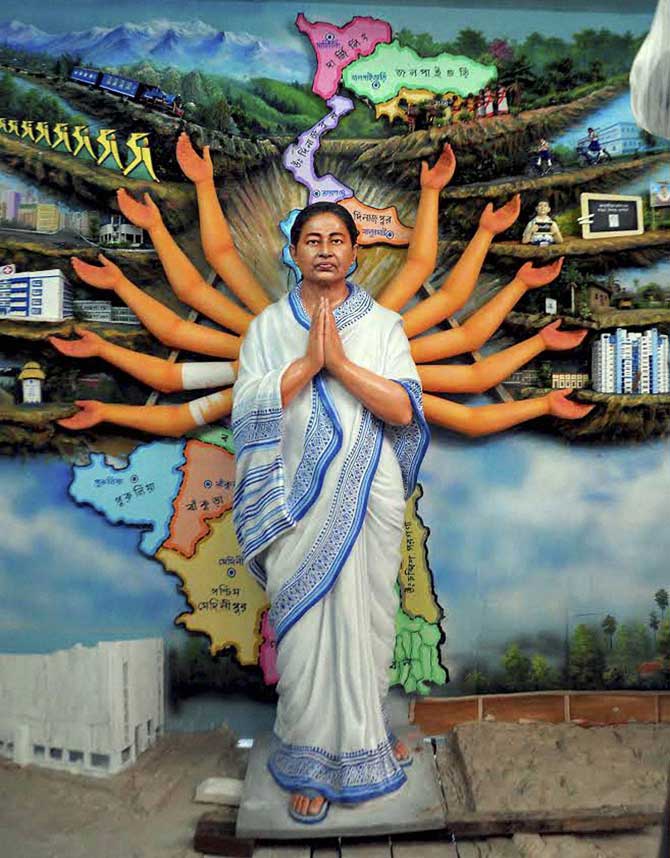 West Bengal Chief Minister Mamata Banerjee shown as Devi Durga at a clay model at a pandal for the upcoming community puja pandal in Nadia district of Bengal on Monday. PTI