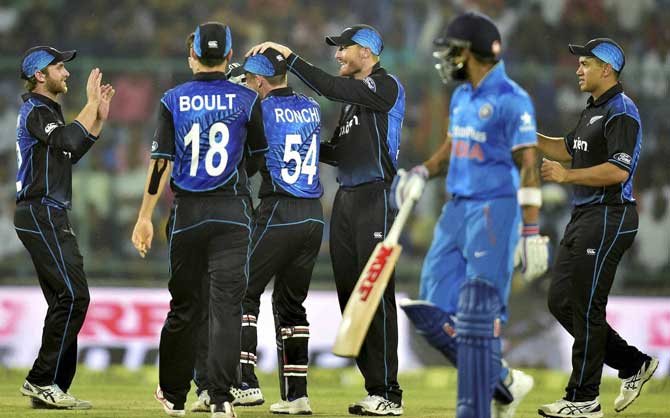 New Zealand cricketers celebrate the fall of an Indian wicket during the 2nd ODI match in New Delhi on Thursday.