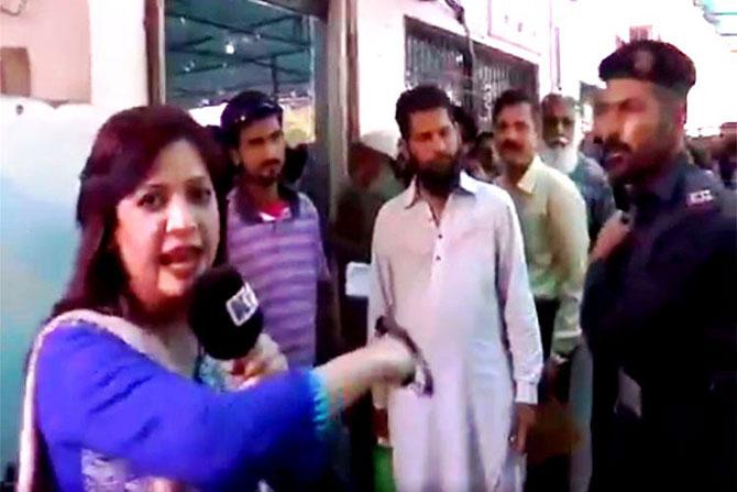 Videograb of Saima Kanwal in the middle of her live broadcast in Karachi, Pakistan, before the trooper hit her. Pic courtesy Twitter