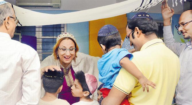 Rabbi Judith Edelman-Green blesses Jewish children on the occasion of Simchat Torah last Sunday evening. PICS/SNEHA KHARABE
