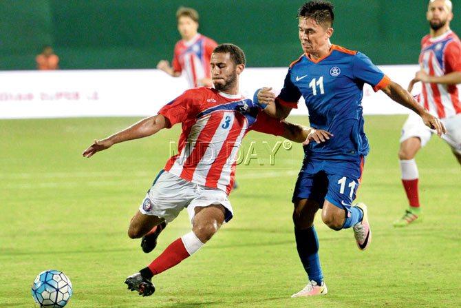 India striker Sunil Chettri is tackled by Puerto Rico’s Jacob Conde during an international friendly on Saturday. pic/suresh karkera 