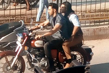 Why is Varun Dhawan not wearing a helmet while riding a bike?