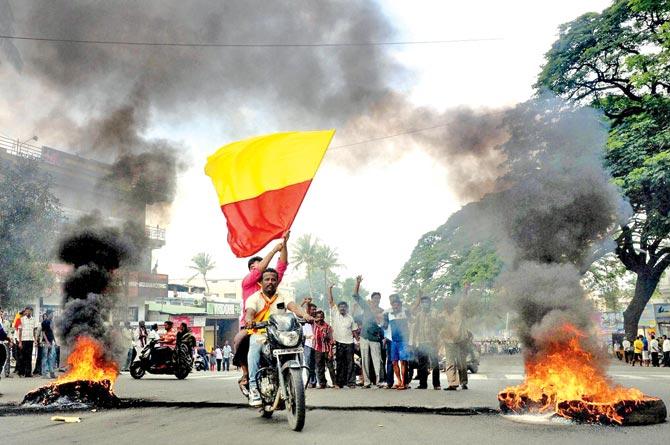 Pro-Kannada activists burn tyres to block the road during the Karnataka Bandh in Bengaluru