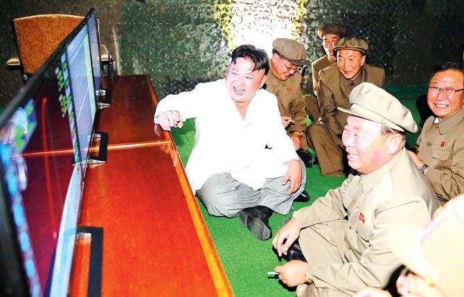 An undated file photo shows North Korean leader Kim Jong-Un inspecting a test-fire of strategic submarine-launched ballistic missile