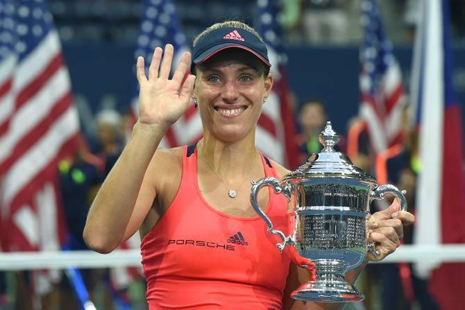 Angelique Kerber of Germany poses with her winning trophy. Pic/AFP
