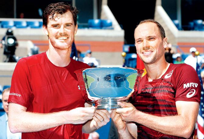 Jamie Murray (left) and partner Bruno Soares pose with their trophy after winning the US Open men