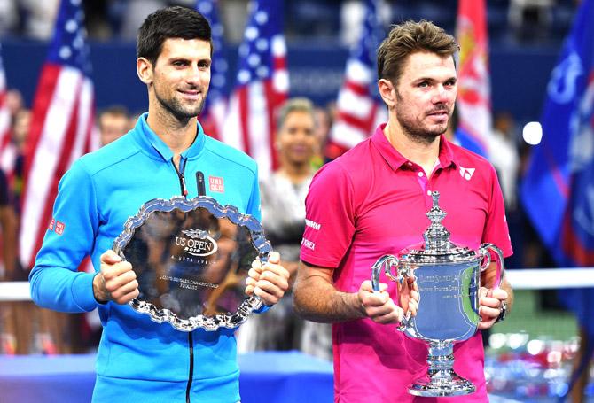 Stan Wawrinka (R) of Switzerland and Novak Djokovic (L) of Serbia pose with their trophies after their Men