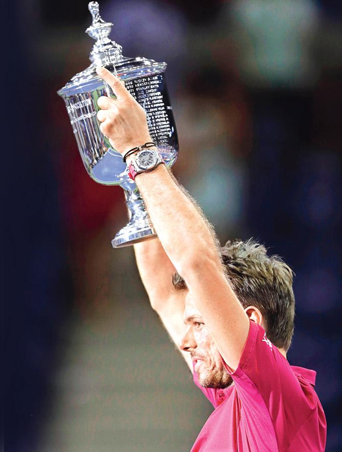 Stanislas Wawrinka holds aloft the US Open trophy after beating Novak Djokovic in New York on Sunday. Pic/AP 