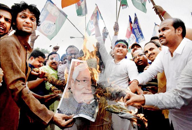 BJP activists burn posters of Bihar CM Nitish Kumar to protest former RJD MP Shahabuddin
