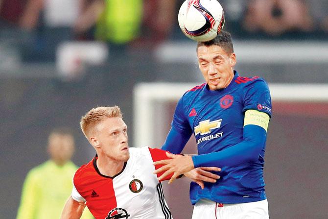 Manchester United defender Chris Smalling (right) and Feyenoord’s Nicolai Joergensen tussle for the  ball during the Europa League tie at Feijenoord Stadion in Rotterdam on Thursday. Pic/Getty Images