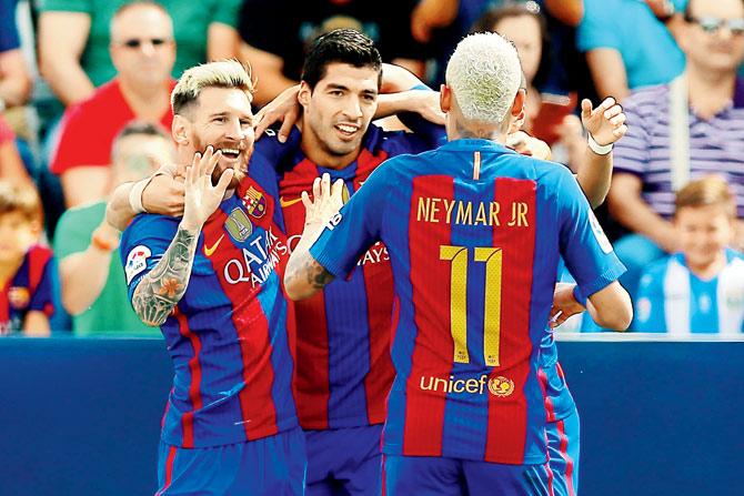Messi (left) celebrates a goal with teammates Suarez and Neymar during the Barca vs Leganés match on Saturday. Pic/Getty Images