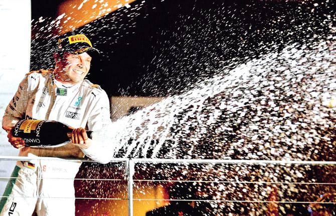 Nico Rosberg sprays champagne as he celebrates his Singapore Formula One Grand Prix win at Marina Bay Street circuit yesterday. Pic/AP,PTI