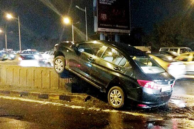 The car that climbed on the divider. PIC/Asif Rizvi