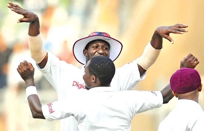 WI captain Darren Sammy celebrates with a teammate after the third Test against India ended in a draw at Wankhede in 2011