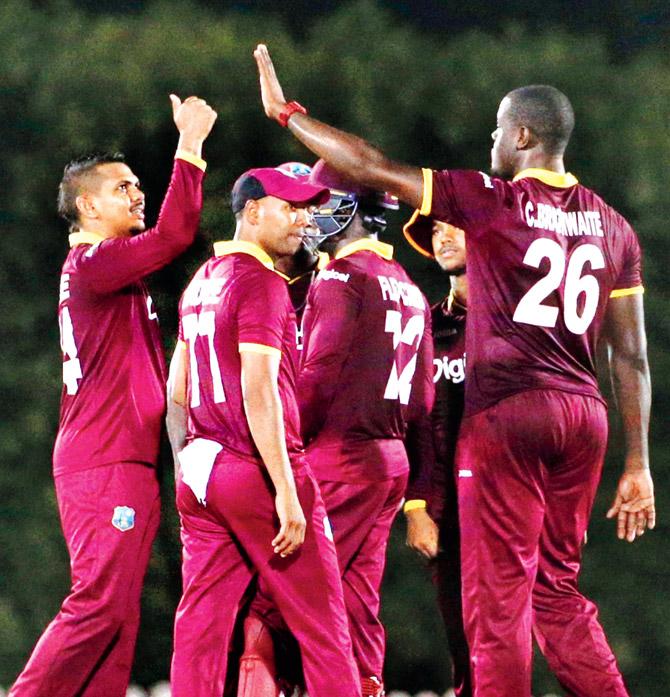 West Indies cricket players celebrates during the warm-up game against Emirates Cricket Board XI at the ICC Academy in Dubai. Pic/AFP