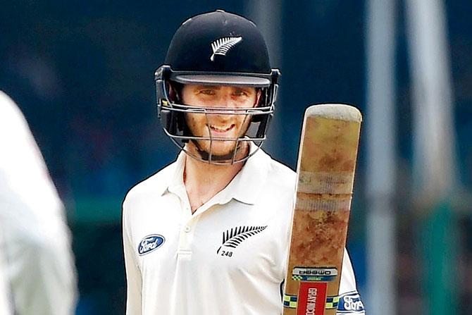 New Zealand’s captain Kane Williamson raises his bat to celebrate his half century during the second day’s play of the first Test against India at Green Park in Kanpur yesterday. PIC/ AFP 