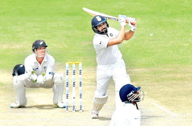 Rohit Sharma plays a lofted shot during the penultimate day of the Kanpur Test against New Zealand at Green Park yesterday. Pic/PTI