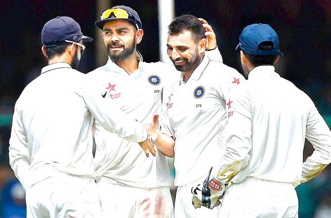 Mohammed Shami celebrates the dismissal of Mark Craig with skipper Virat Kohli and other Indian teammates yesterday. Pic/AFP