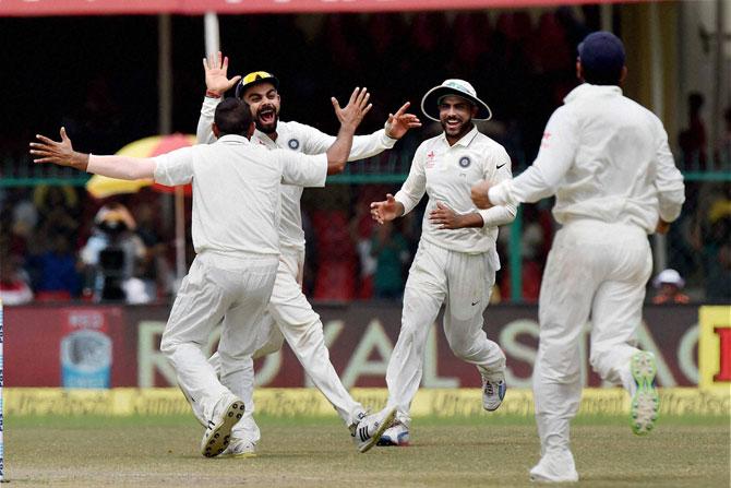 Indian players celebrate a New Zealand wicket during the 5th Day of Kanpur Test. Pic/ PTI