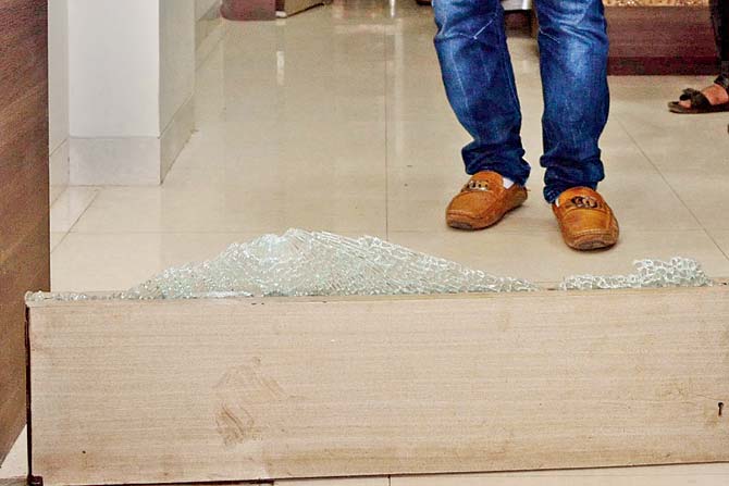 The shattered glass of Sumit Chakraborthy’s office after Suresh Pujari’s met shot at it in July this year