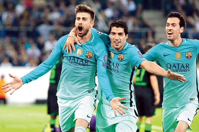 Gerard Pique celebrates after scoring Barcelona’s winning goal with his teammates during the Champions League tie against Borussia Monchengladbach on Wednesday