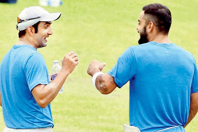 Gautam Gambhir (left) and skipper Virat Kohli share a lighter moment during a training session at Eden Gardens in Kolkata yesterday. PIC/PTI
