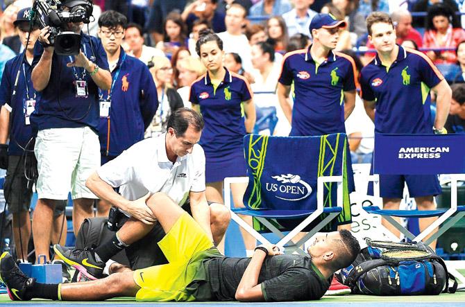 Nick Kyrgios gets treated for an injury on Saturday. Pic/AFP