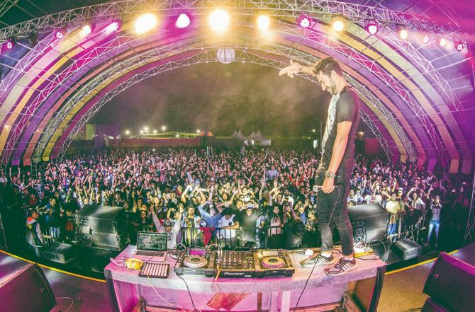 Nucleya (on the table) interacts with fans during a live gig . Pic courtesy/Himanshu Rohilla