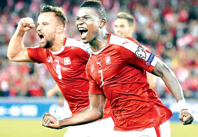 Switzerland forward Breel Embolo (right) celebrates his team