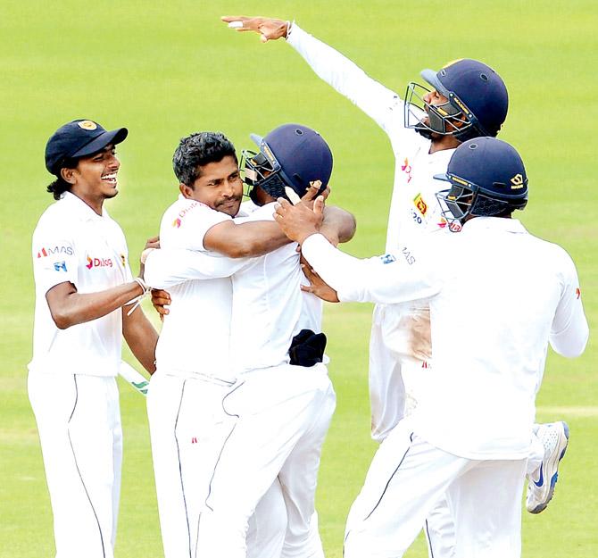 Sri Lankan spinner Rangana Herath celebrates the wicket of Australia