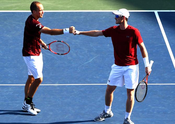 Jamie Murray (R) of Great Britain and Bruno Soares of Brazil react against Pierre-Hugues Herbert and Nicolas Mahut of France during their Men
