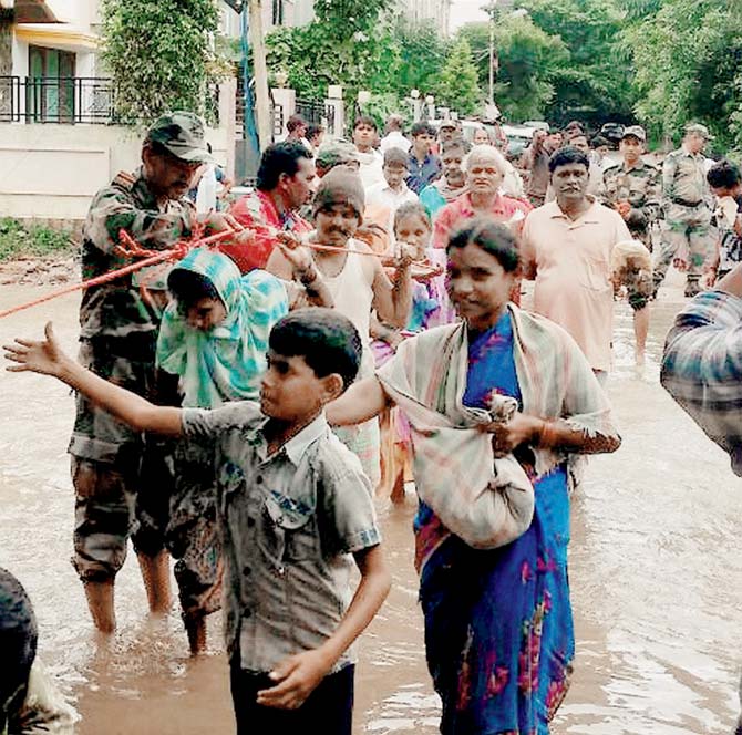 Army personnel helping people in Hyderabad on Saturday. Pic/PTI 