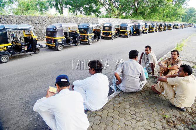 Auto drivers wait at Express Highway Service Road outside Godrej company in Vikhroli for checking of meters and vehicle papers by the RTO. Pic/Sameer Markande