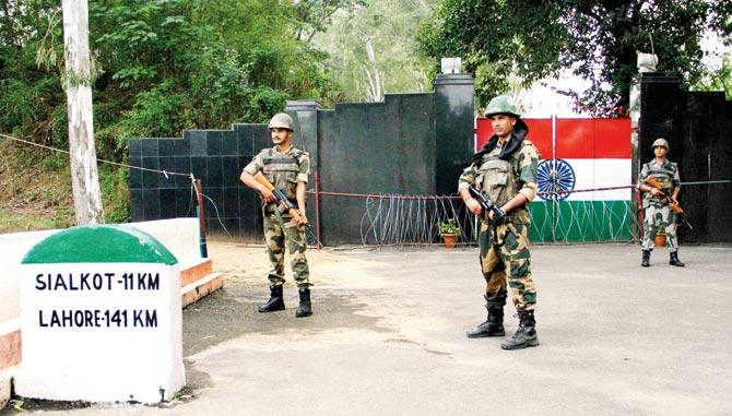 Indian forces keep vigil at the India and Pakistan International Border at RS Pura, about 35 km from Jammu on Saturday. Pic/PTI
