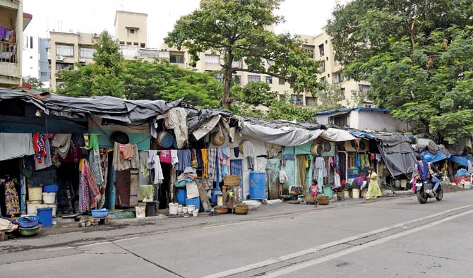 Slums gobble up a pavement at Dockyard Road. Illegal structures are a menace across the ward — they block arterial roads and even lanes leading to hospitals. Pics/Pradeep Dhivar