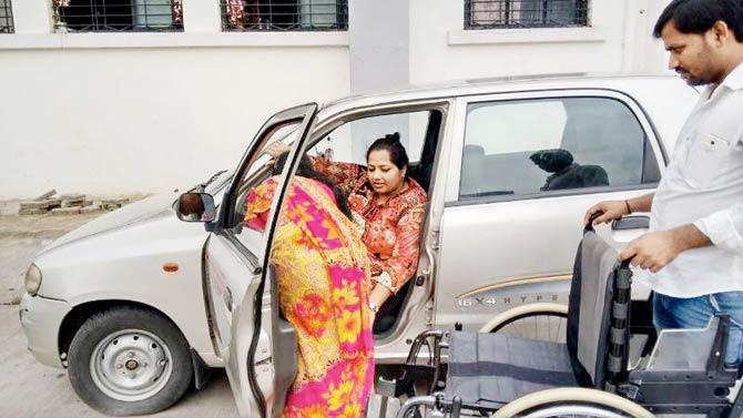 The disabled medical officer’s maid helps her get out of the car