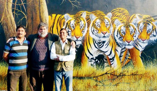 Valmik Thapar with master painters Gajanand Singh and Narayan Singh who created art works at Ranthambhore railway station, an initiative by Thapar