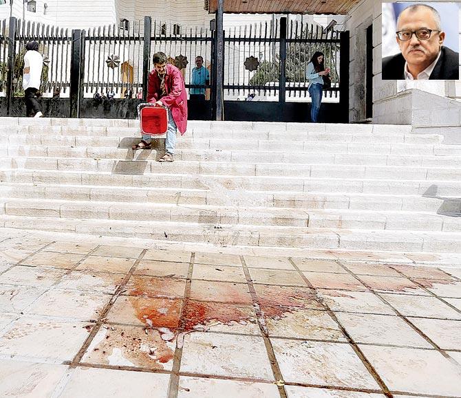 A man cleans (inset) Hattar’s blood after he was shot dead outside a Amman court on Sunday. Pic/AFP