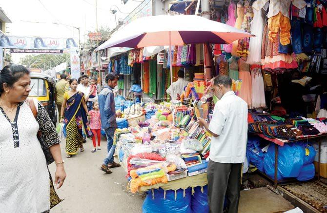 A hawker illegally sets up his stall outside the Goregaon railway station. Locals allege that such encroachers are regularly driven away, but they return to their old spots within no time