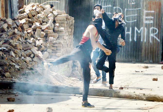 Kashmiri protestors pelt bricks and rocks as clashes with the security forces continued this weekend. Pic/AFP