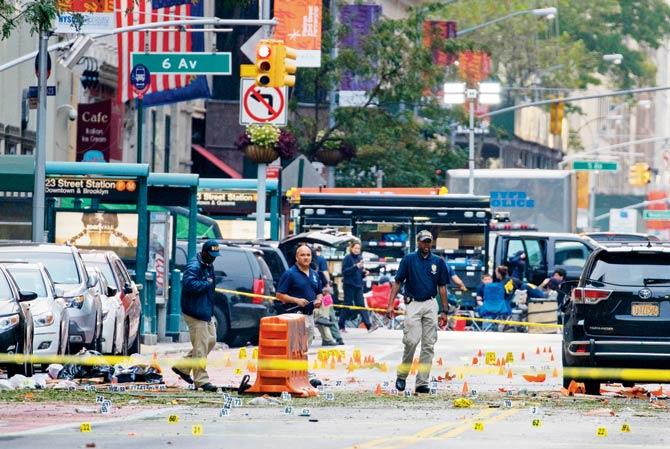 Crime scene investigators work at the scene of the explosion in Chelsea, New York. Pic/AP