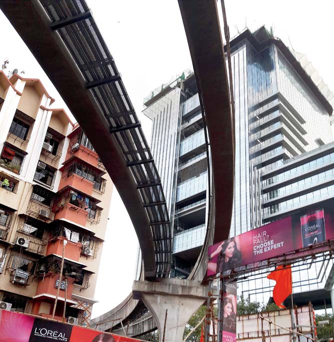 The monorail guideway beams circle through congested areas in the city