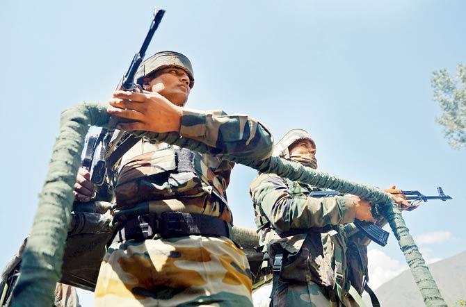 Soldiers on guard after clashes with terrorists in Bandipora. Pic/PTI