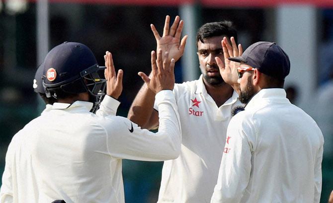 Ravichandran Ashwin with teammates celebrates the wicket of New Zealand skipper Kane Williamson on the fourth day of the first Test match at Green Park in Kanpur on Sunday