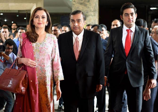 Reliance Industries chairman, Mukesh Ambani arrives with his wife Nita and son Akash for the company