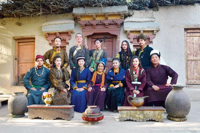 A group of volunteers in traditional Ladakhi outfits with Rigzin Dolma (front row, centre) outside Raku House